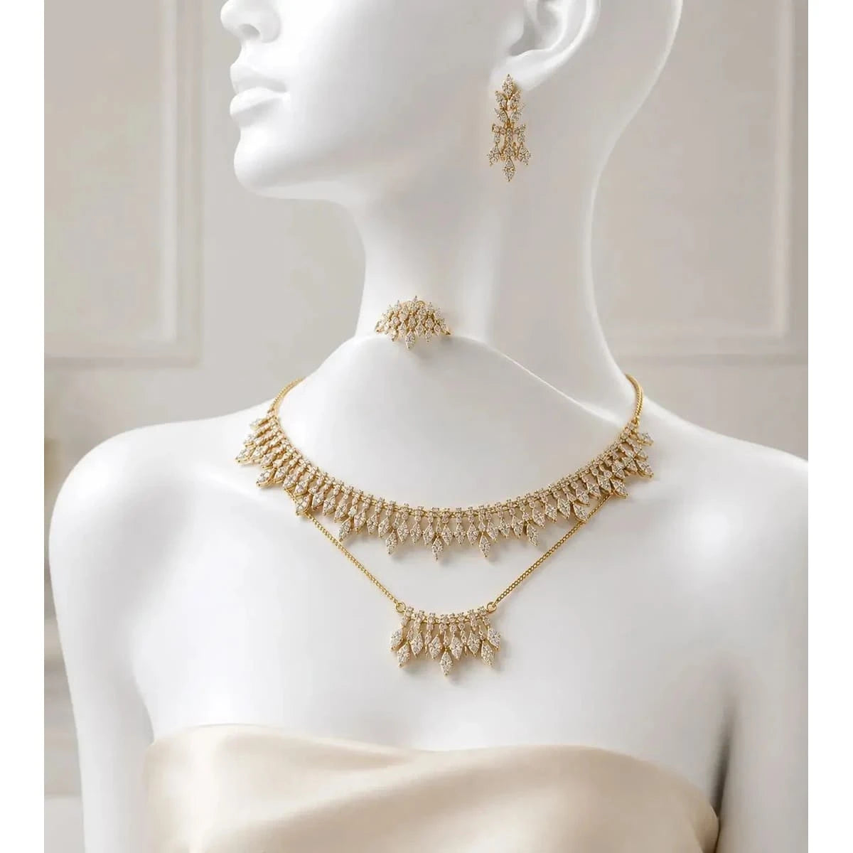 Elegant HAFIZ AND CO jewelry set featuring matching necklace, earrings, and bracelet in intricate gold-tone design.