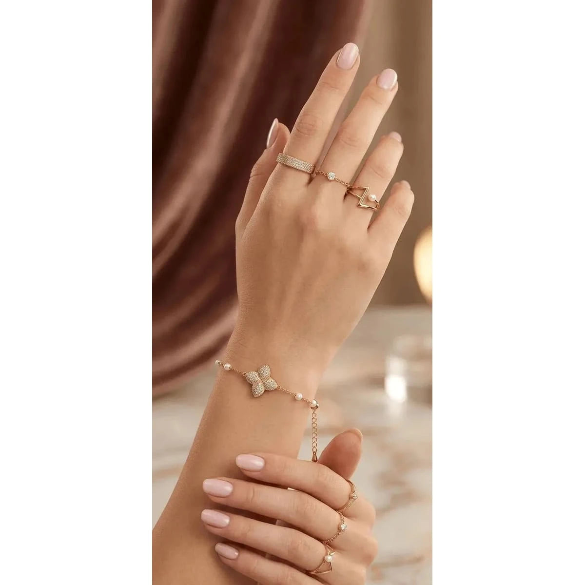Gold HAFIZ AND CO butterfly charm adjustable bangle bracelet with delicate butterfly details and sleek design.