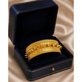 Elegant gold bangle by HAFIZ AND CO, showcasing a sleek, smooth design with a polished finish on a white background.