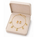 Elegant gold necklace from HAFIZ AND CO featuring intricate design and polished finish, displayed on a neutral background.