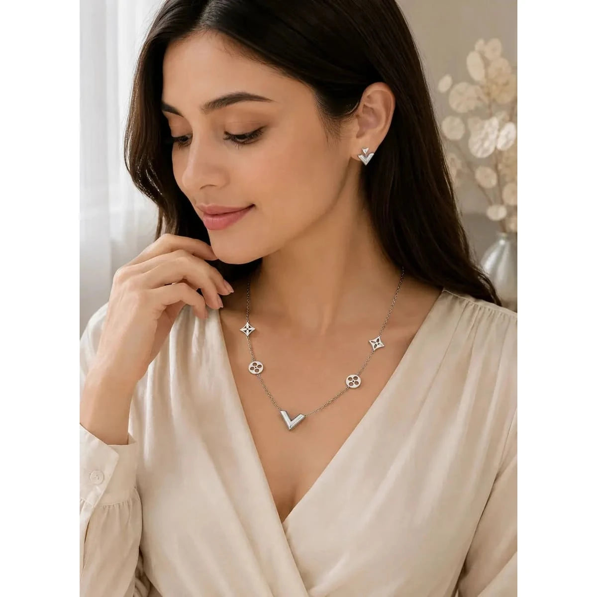 Elegant V-shaped necklace from HAFIZ AND CO, featuring intricate jewelry design with a polished finish and delicate chain.