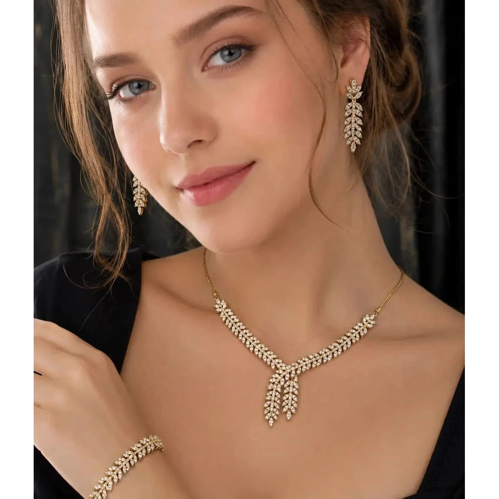 HAFIZ AND CO Golden Laurel jewelry set featuring matching necklace and earrings with intricate gold design.