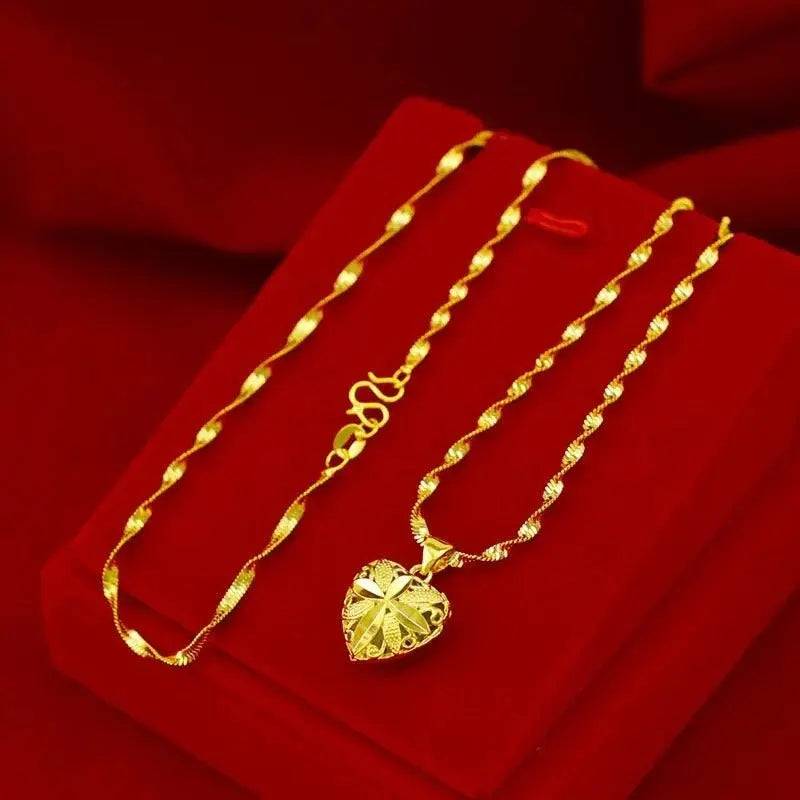 Elegant gold heart pendant necklace on a red velvet jewelry box.