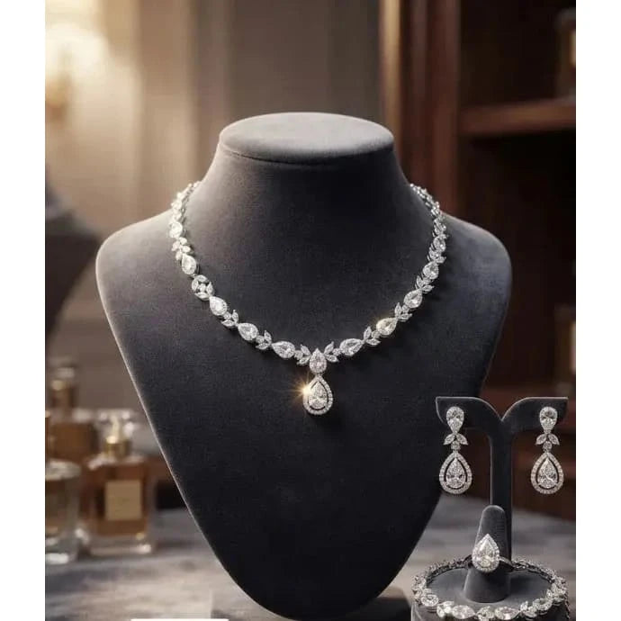 HAFIZ AND CO premium jewelry set featuring intricate necklace and matching earrings in gold-tone metal with gemstone accents.