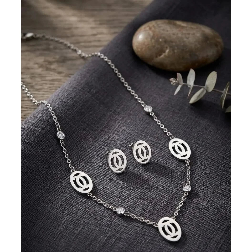 Silver jewelry set by HAFIZ AND CO featuring a necklace and matching stud earrings, crafted with intricate detailing.