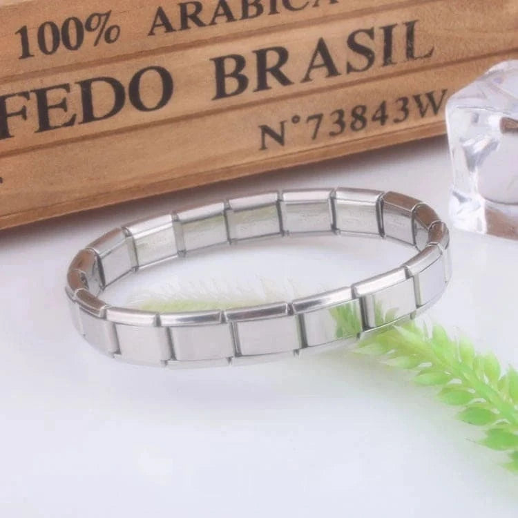 Silver HAFIZ AND CO bangle with stretch link design, showcasing a sleek and shiny jewelry piece for everyday wear.