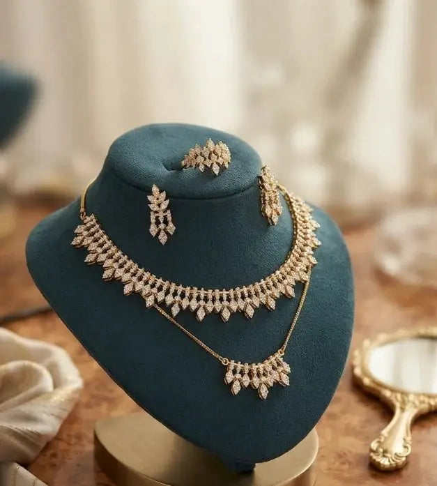 HAFIZ AND CO jewelry set featuring matching earrings and necklace with intricate design and sparkling gemstones.