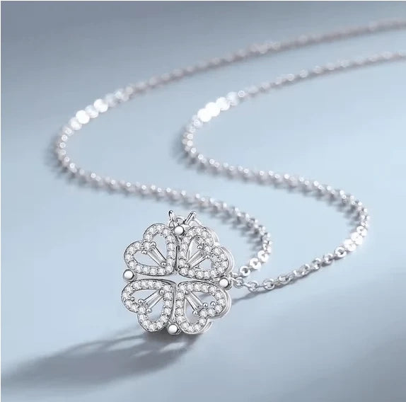 Gold flower four-leaf necklace by HAFIZ AND CO featuring a delicate floral pendant on a fine chain.