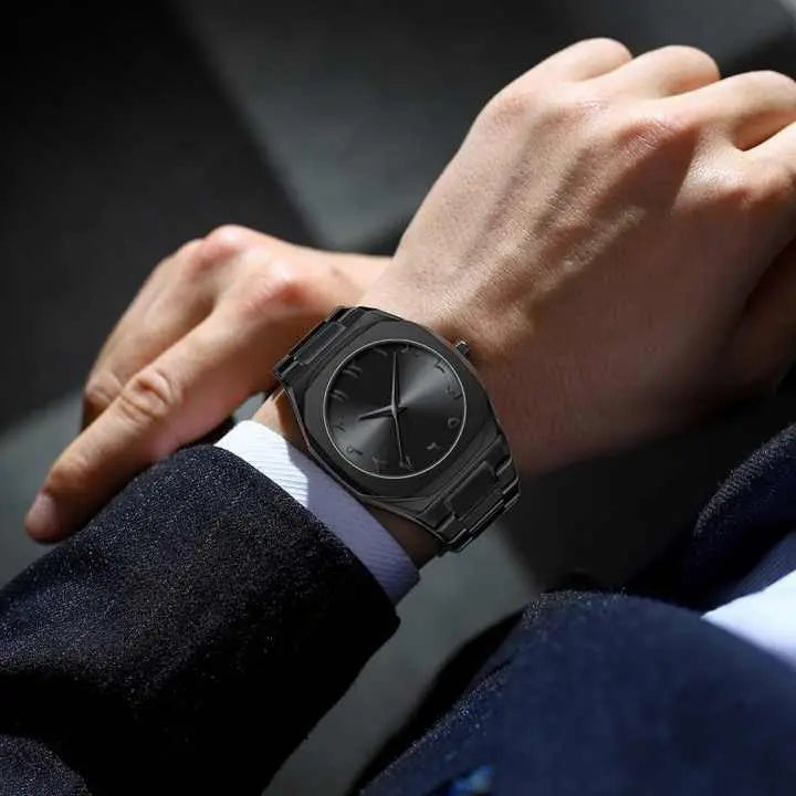 Stainless steel Arabic watch by Zambeel showing a sleek round dial with Arabic numerals and a stainless steel band.