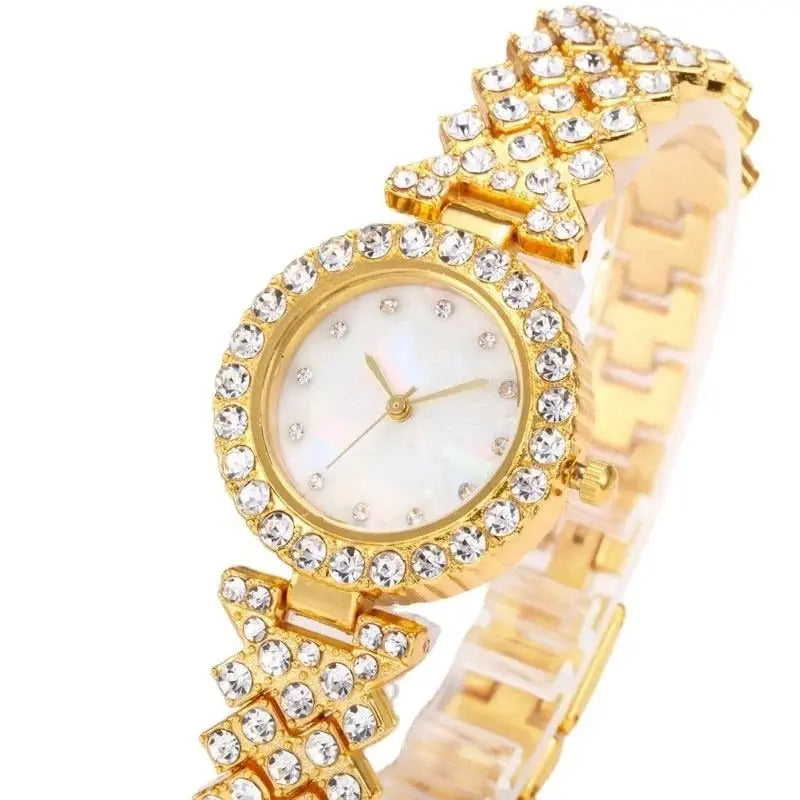 Gold women's quartz watch by Zambeel with diamond accents and alloy band, showcasing a sleek and elegant design.