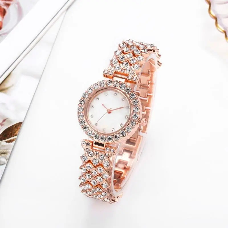 Women's gold quartz watch by Zambeel with diamond accents and alloy case, featuring a sleek and elegant design.